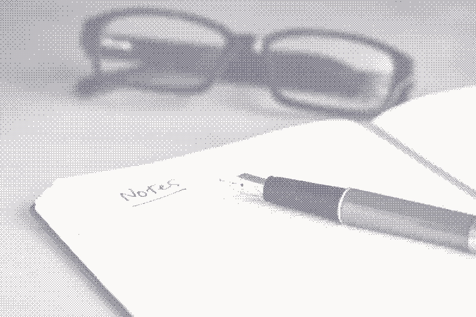 A fountain pen resting on an open ruled notebook beside a pair of reading glasses