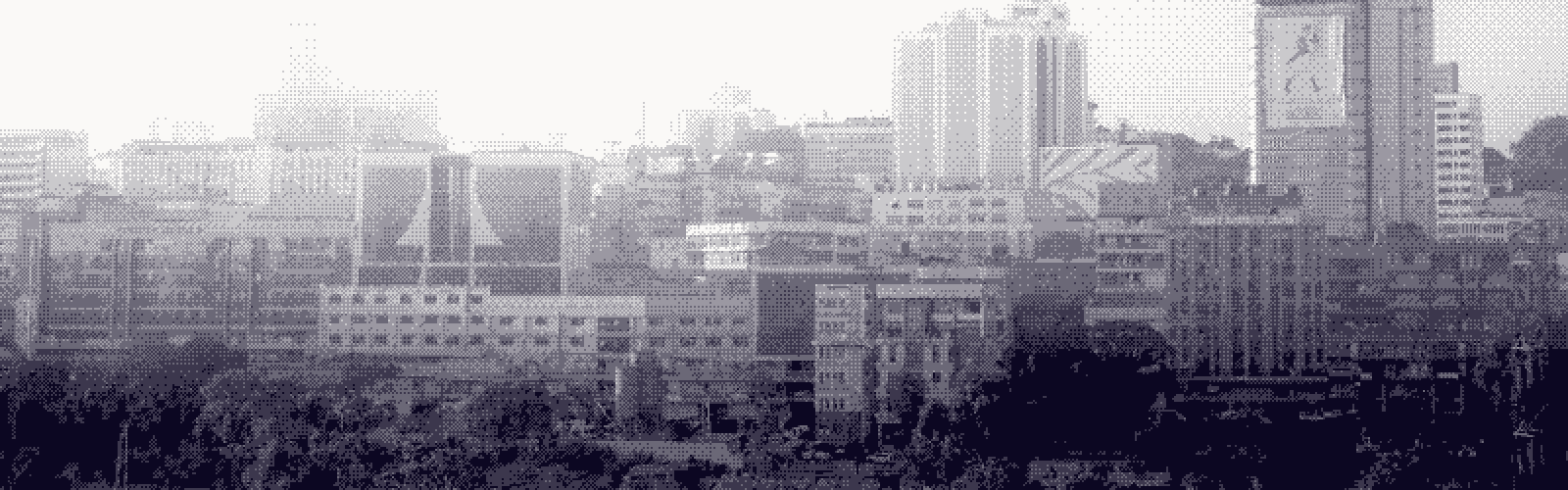 Kampala's skyline stepping up across the hills, towers layered in evening haze