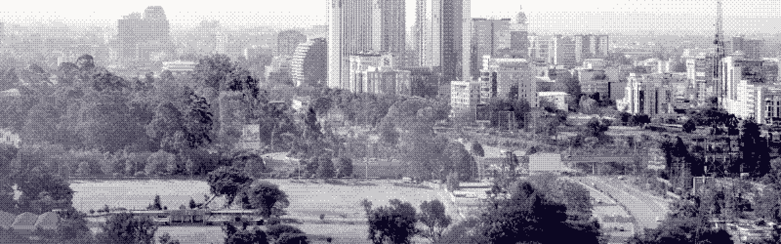 Nairobi's tower cluster seen across parkland, the city hazy in the middle distance