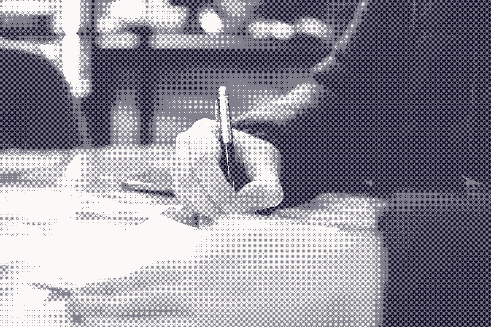 A hand writing with a pen on loose paper, black and white, background falling out of focus